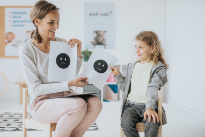 a female psychologist talking about feelings with the little girl