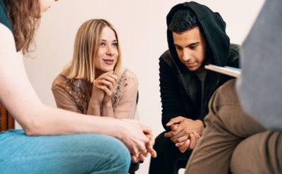 group of teenagers sitting together and smiling