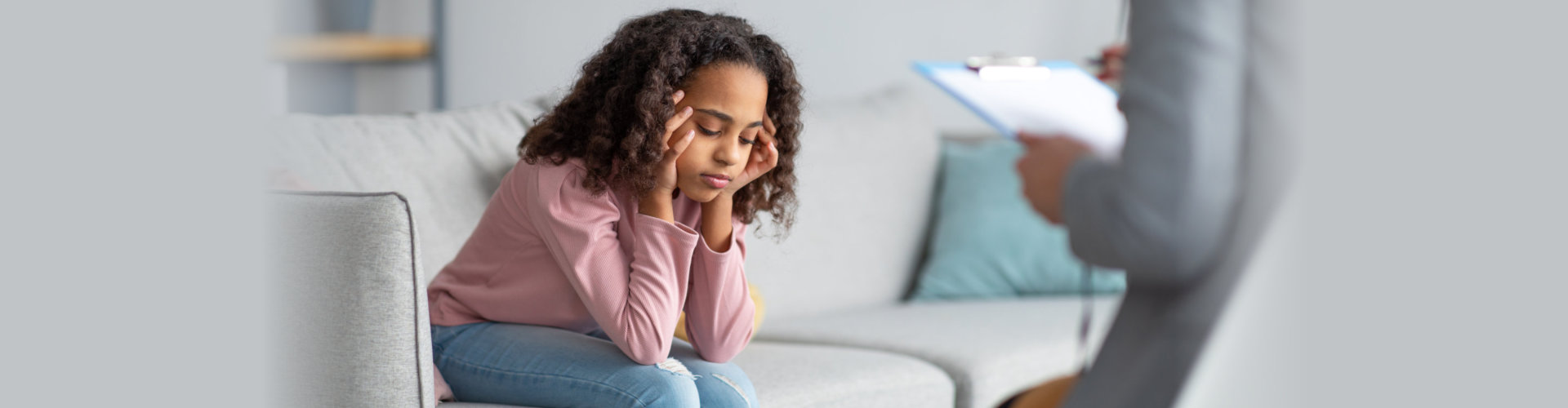 unhappy girl listening to psychologist at meeting